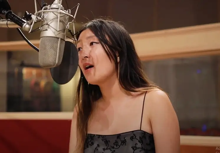 A woman is singing into a microphone